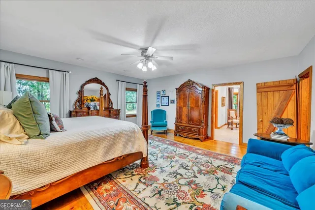 a bathroom with a sink a large mirror and a toilet