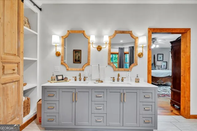 a bathroom with a sink a toilet and a mirror