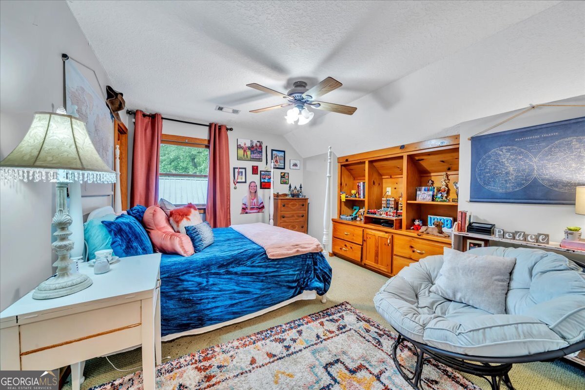 568 Hopewell Church Road Rhine, GA 31077 - Photo 26 of 77 a living room with furniture and a flat screen tv
