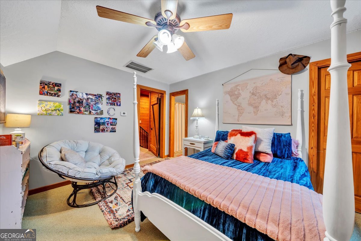 568 Hopewell Church Road Rhine, GA 31077 - Photo 27 of 77 a bedroom with a bed and dresser with mirror