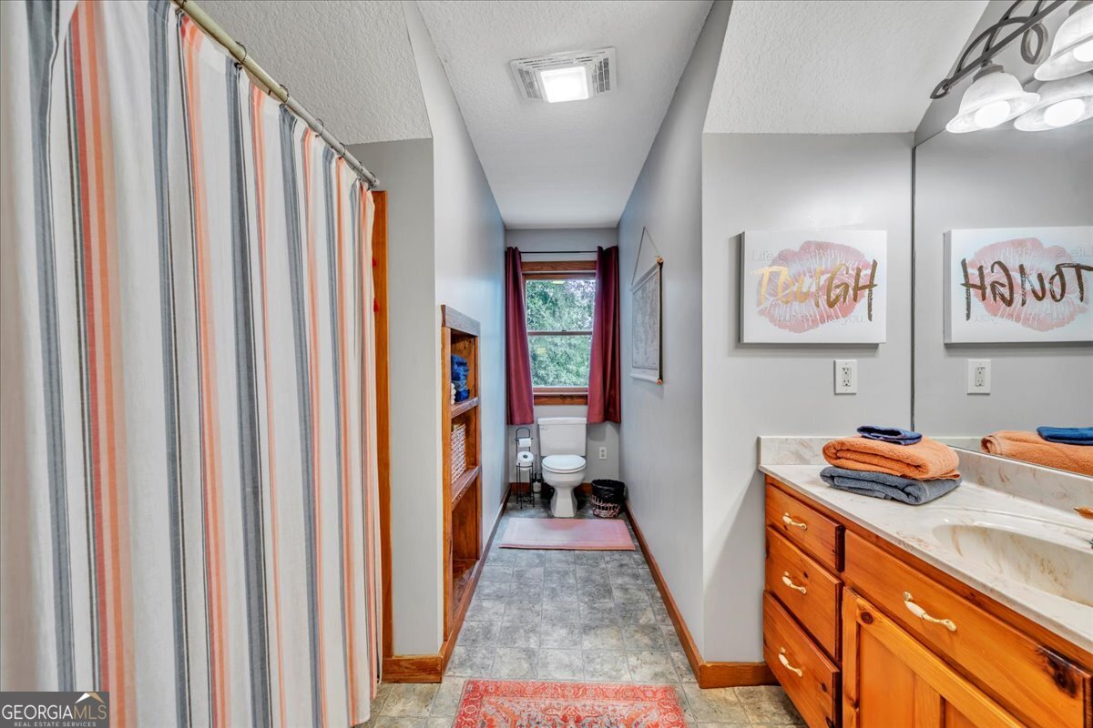 568 Hopewell Church Road Rhine, GA 31077 - Photo 29 of 77 a hallway with a view of bedroom with furniture and a window