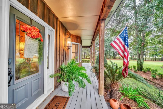 a building outdoor space with patio furniture and potted plants