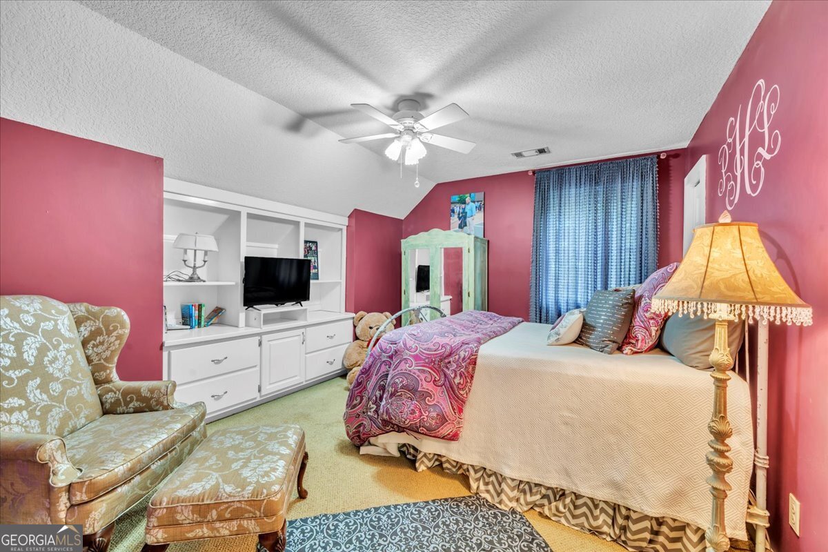 568 Hopewell Church Road Rhine, GA 31077 - Photo 31 of 77 a bedroom with a bed and a couch