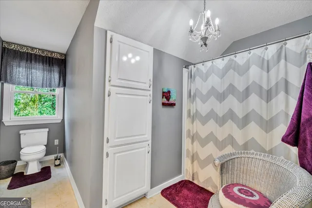 a view of a chairs and table in the back yard of the house