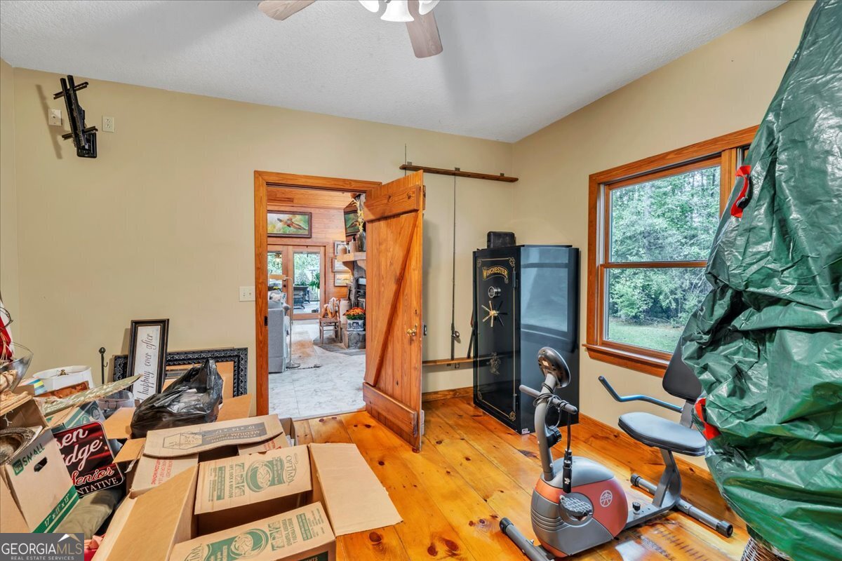 568 Hopewell Church Road Rhine, GA 31077 - Photo 37 of 77 a view of a livingroom with furniture and gym equipment