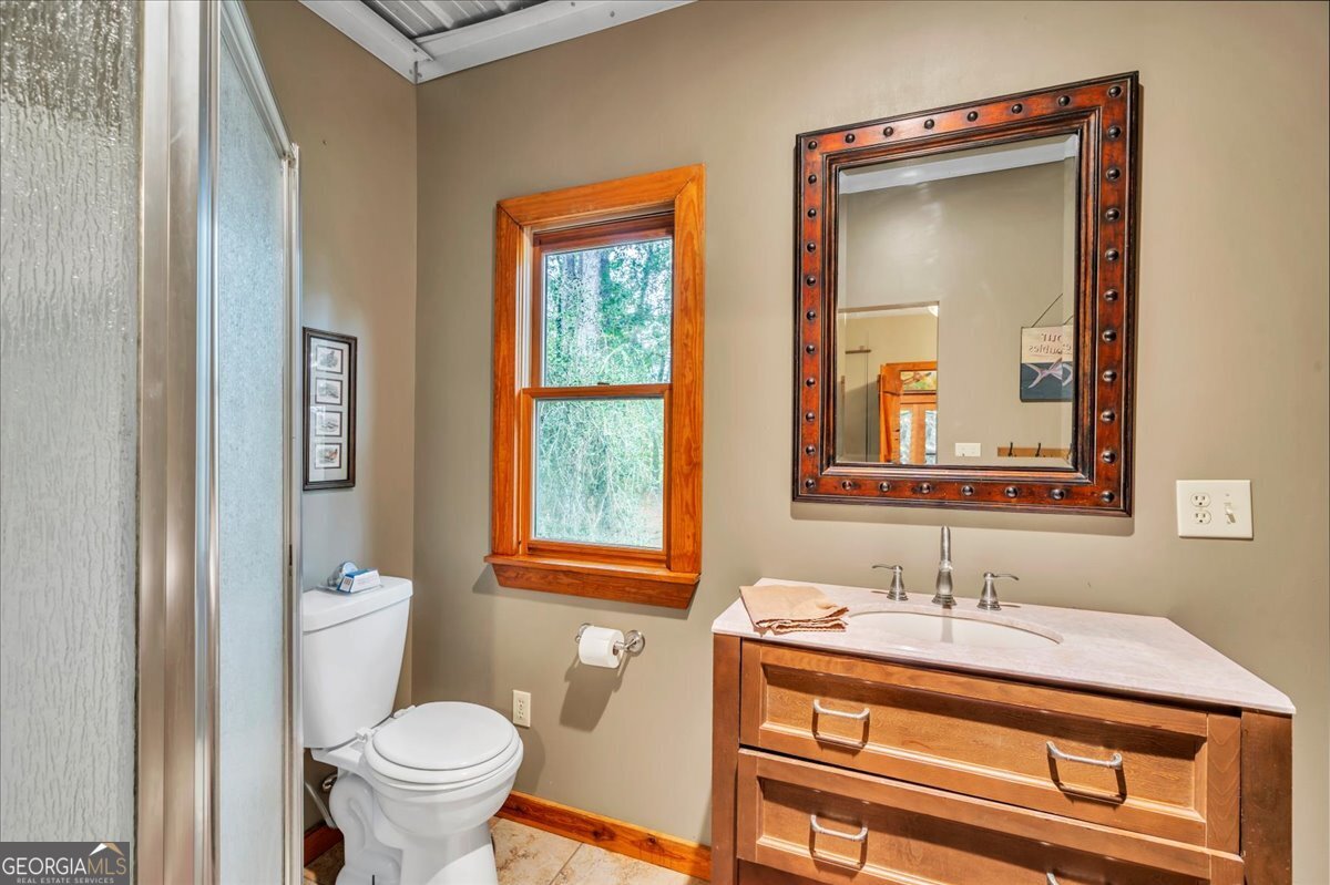 568 Hopewell Church Road Rhine, GA 31077 - Photo 38 of 77 a bathroom with a sink a toilet and a mirror