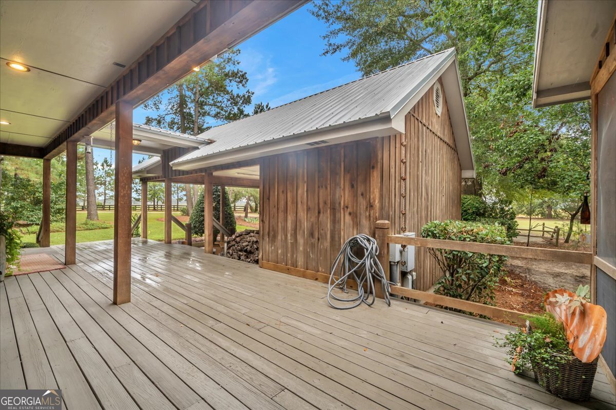 568 Hopewell Church Road Rhine, GA 31077 - Photo 43 of 77 a view of a deck with wooden floor and roof with a garden view
