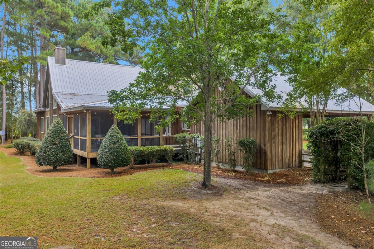 568 Hopewell Church Road Rhine, GA 31077 - Photo 69 of 77 a backyard of a house with plants and tree