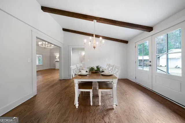 a dining room with furniture and wooden floor