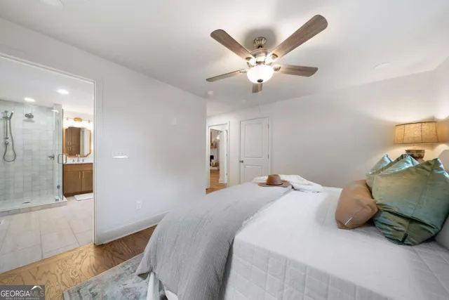 a bedroom with a large bed and a chandelier