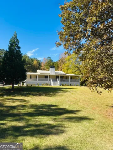a front view of a house with a big yard