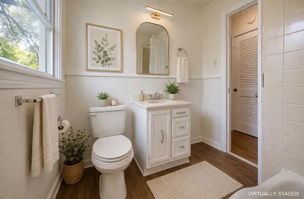 a bathroom with a toilet a sink and mirror