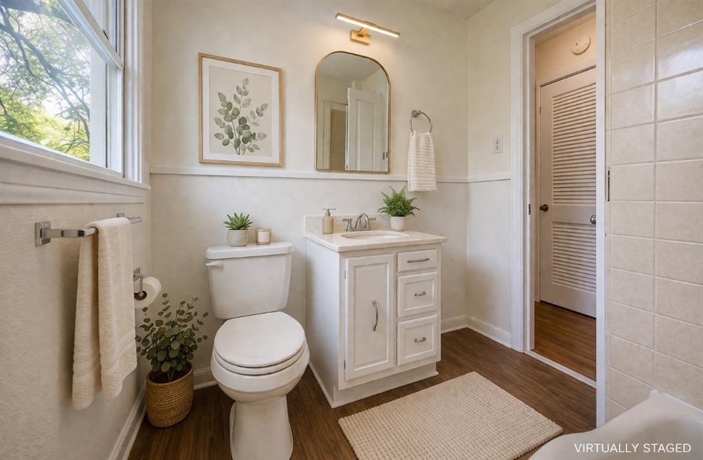 211 West Long Street Elm Mott, TX 76640 - Photo 11 of 16 a bathroom with a toilet a sink and mirror