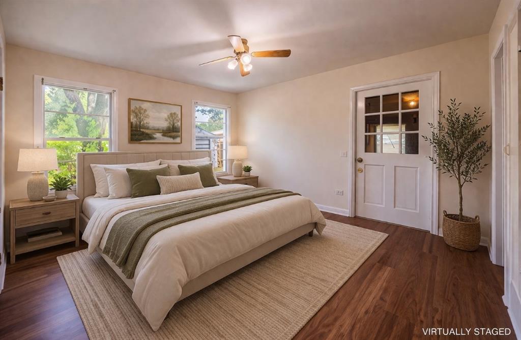 211 West Long Street Elm Mott, TX 76640 - Photo 12 of 16 a bedroom with a large bed and a chandelier