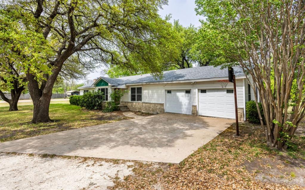 211 West Long Street Elm Mott, TX 76640 - Photo 13 of 16 a view of a yard in front of a house with large tree