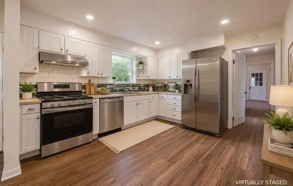 a kitchen with stainless steel appliances granite countertop a stove a refrigerator and a microwave