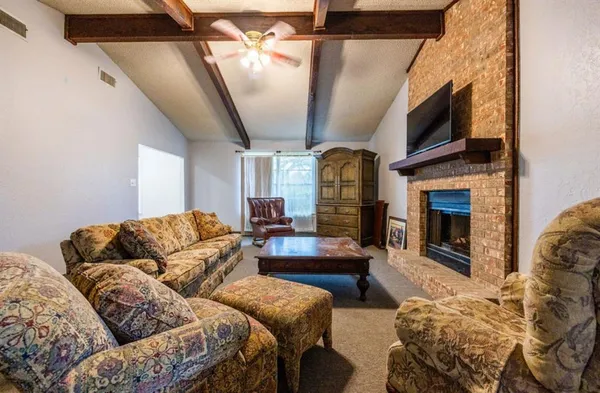 a living room with furniture fireplace and flat screen tv