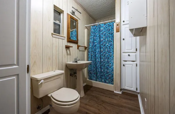 a white toilet sitting next to a bathroom sink