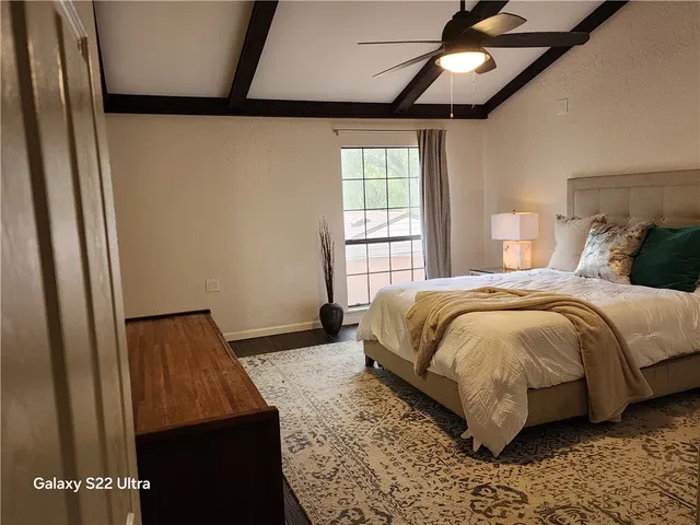 a bedroom with a bed and a window