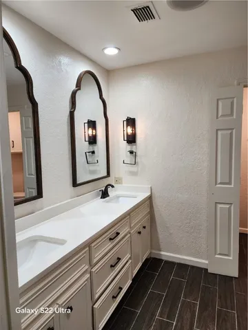 a bathroom with a shower and a sink
