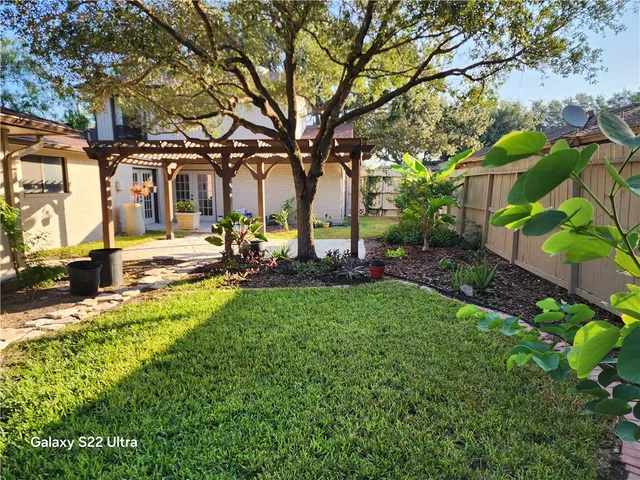 a large bedroom with a bed and glass wall