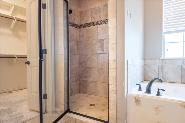 a bathroom with a shower and a sink