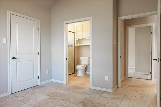 a view of a bathroom with a glass door and a window