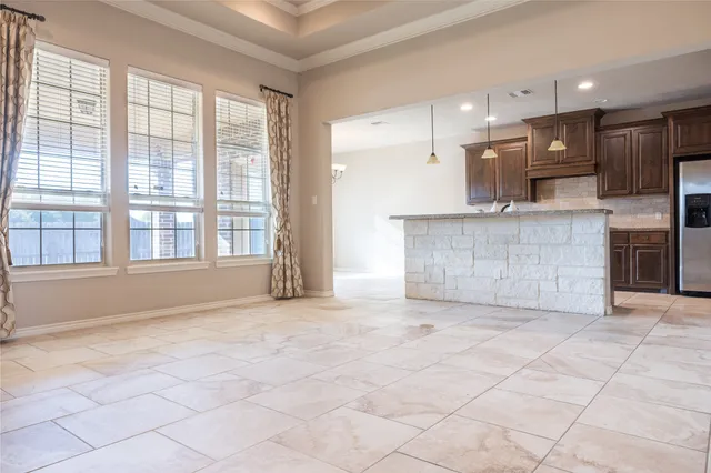 a view of kitchen with stainless steel appliances granite countertop a stove a sink and a refrigerator