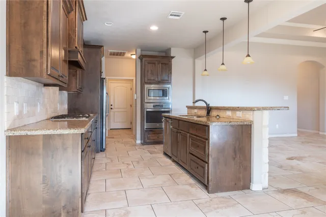 a kitchen with a sink stove and refrigerator