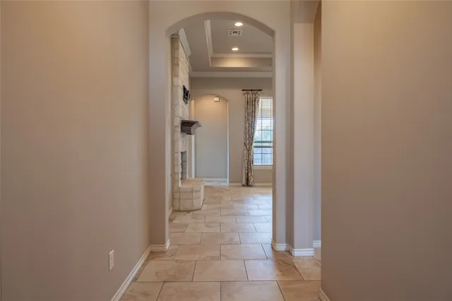 a view of a hallway with wooden shelves