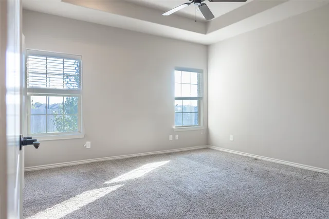 an empty room with windows and closet