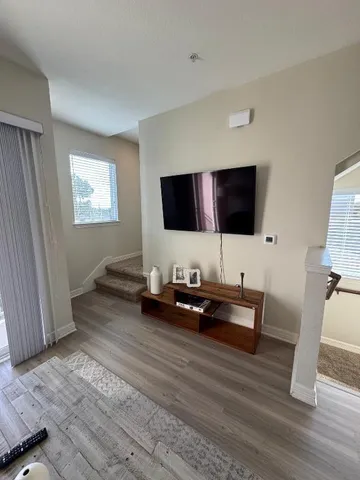 a kitchen with stainless steel appliances granite countertop a refrigerator a stove a sink dishwasher and a stove with wooden floor