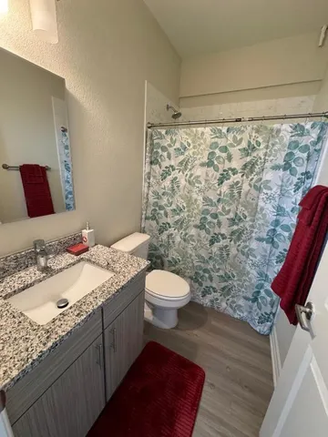 a bathroom with a toilet sink and shower