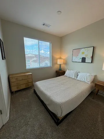 a bedroom with a bed and window