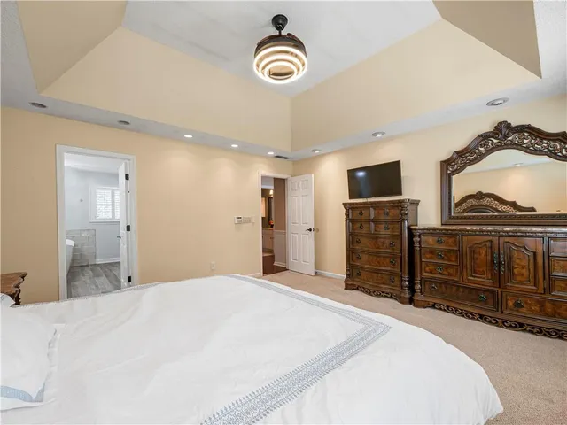 a bed room with a bed and a television