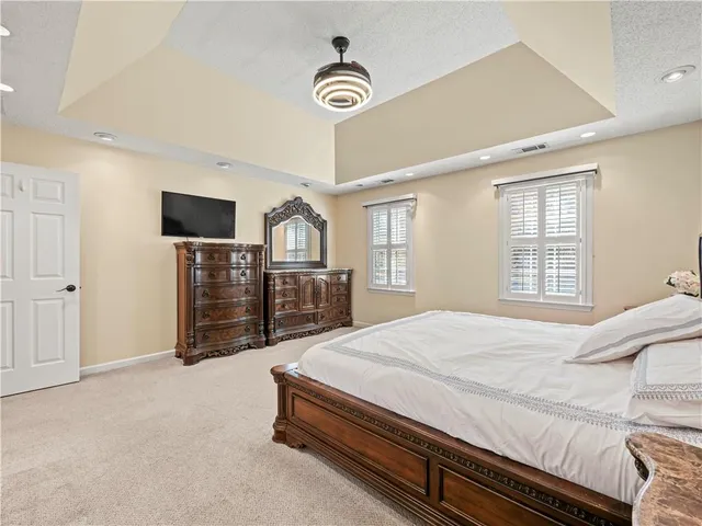 a bathroom with a granite countertop sink mirror and bathtub