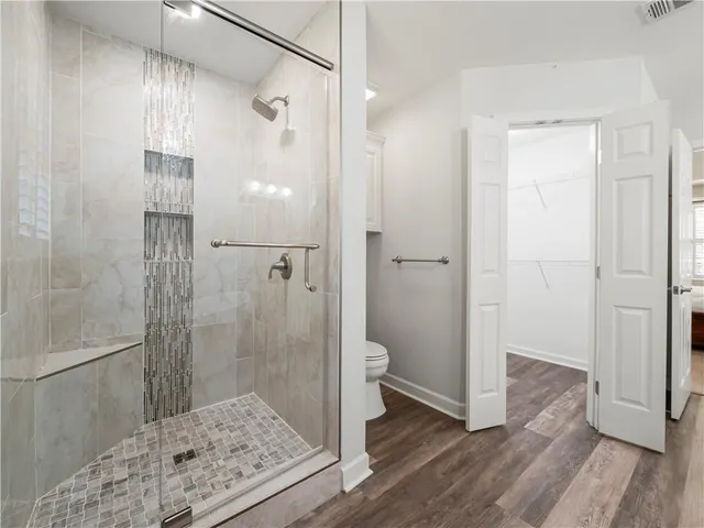 a white bath tub sitting in a bathroom and mirror