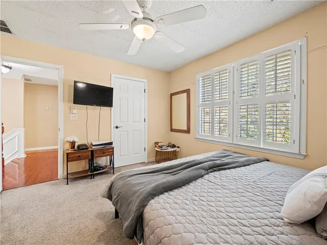 a spacious bedroom with a bed and a window