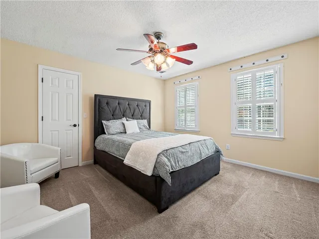 a bedroom with bed and a chandelier