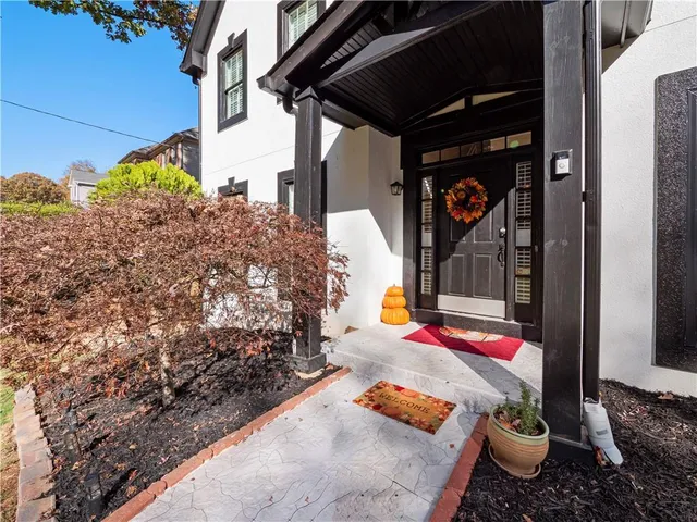 a view of a hallway with wooden floor and glass windows