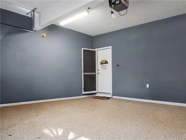 a view of a kitchen with stainless steel appliances granite countertop a stove and a wooden floors