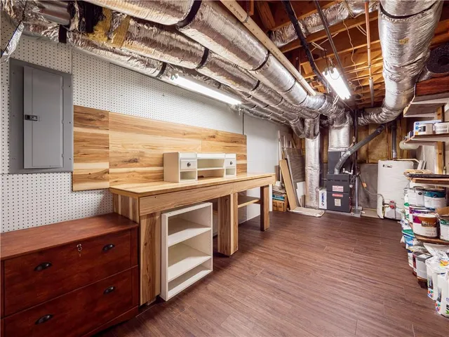 a tall house with a large tree in front of it