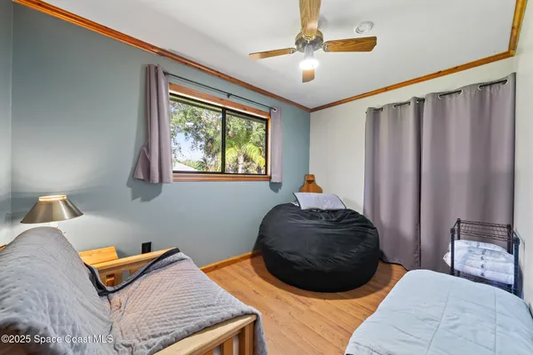 a bed sitting in a bedroom next to a window