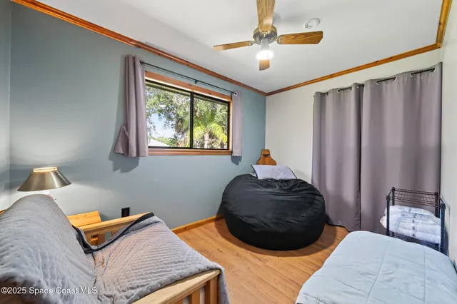 a bed sitting in a bedroom next to a window