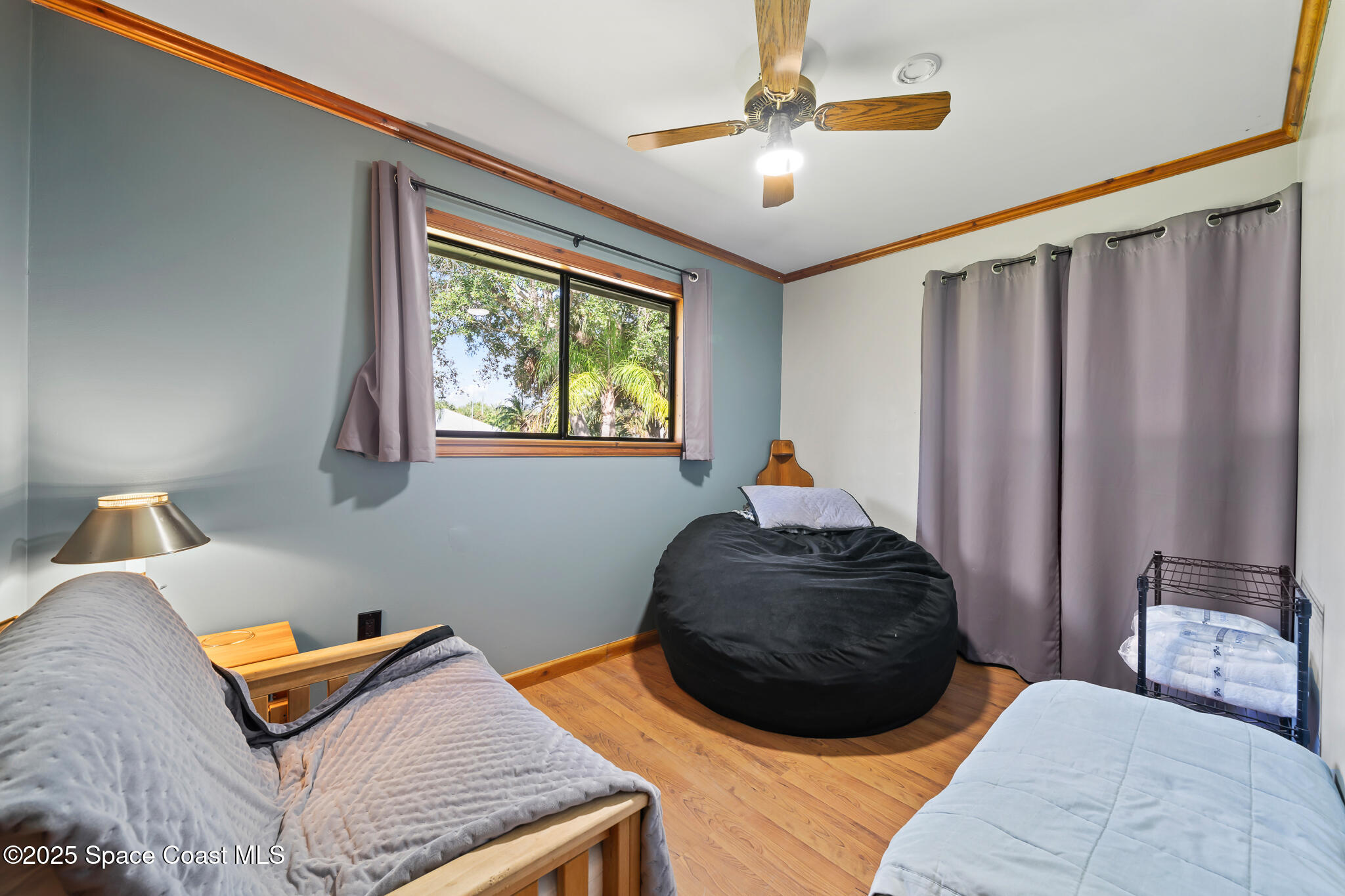 9633 Honeysuckle Drive Sebastian, FL 32976 - Photo 13 of 40 a bedroom with a bed and a chandelier