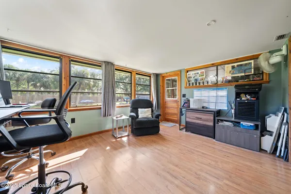 a backyard of a house with lawn chairs and wooden fence