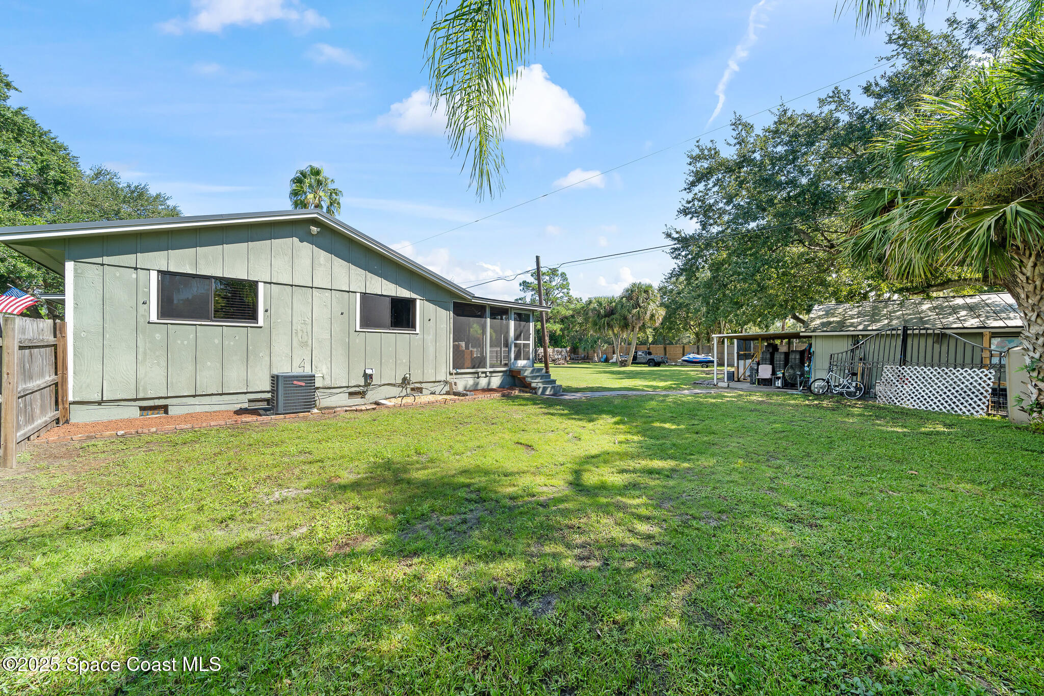 9633 Honeysuckle Drive Sebastian, FL 32976 - Photo 24 of 40 a backyard of a house with table and chairs