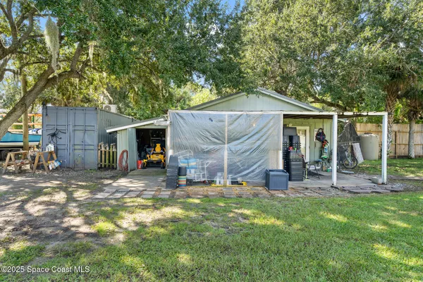 a view of a house with a backyard and a patio
