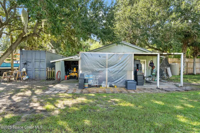 a view of a house with a backyard and a patio