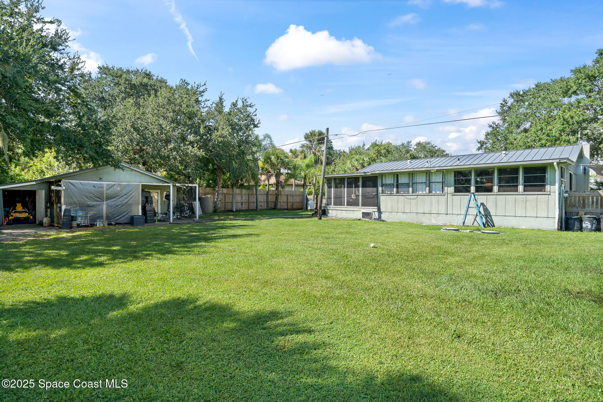 9633 Honeysuckle Drive Sebastian, FL 32976 - Photo 29 of 40 a view of a house with a backyard and a patio